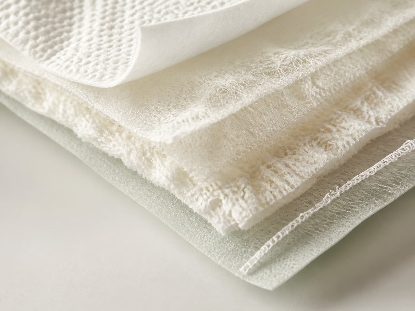 Macro view of layered nonwoven and absorbent hygiene product materials